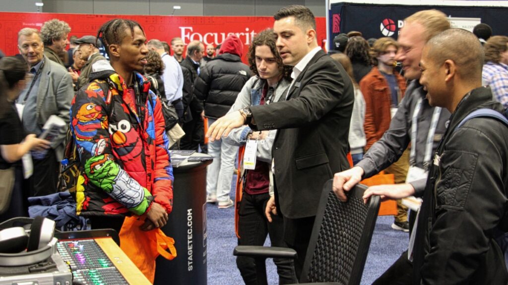 Attendees interact with exhibitors on the bustling show floor during the AES New York 2022 Convention in-person events held at the Javits Center.