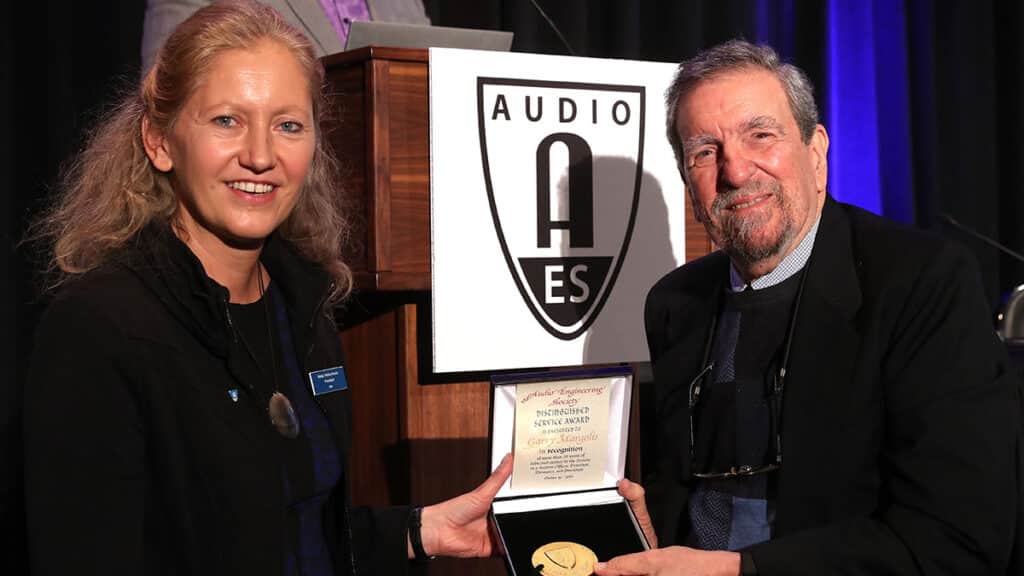 Garry Margolis, AES Past President, receives the AES Distinguished Service Medal in 2019 from then President Nadia Wallaszkovits